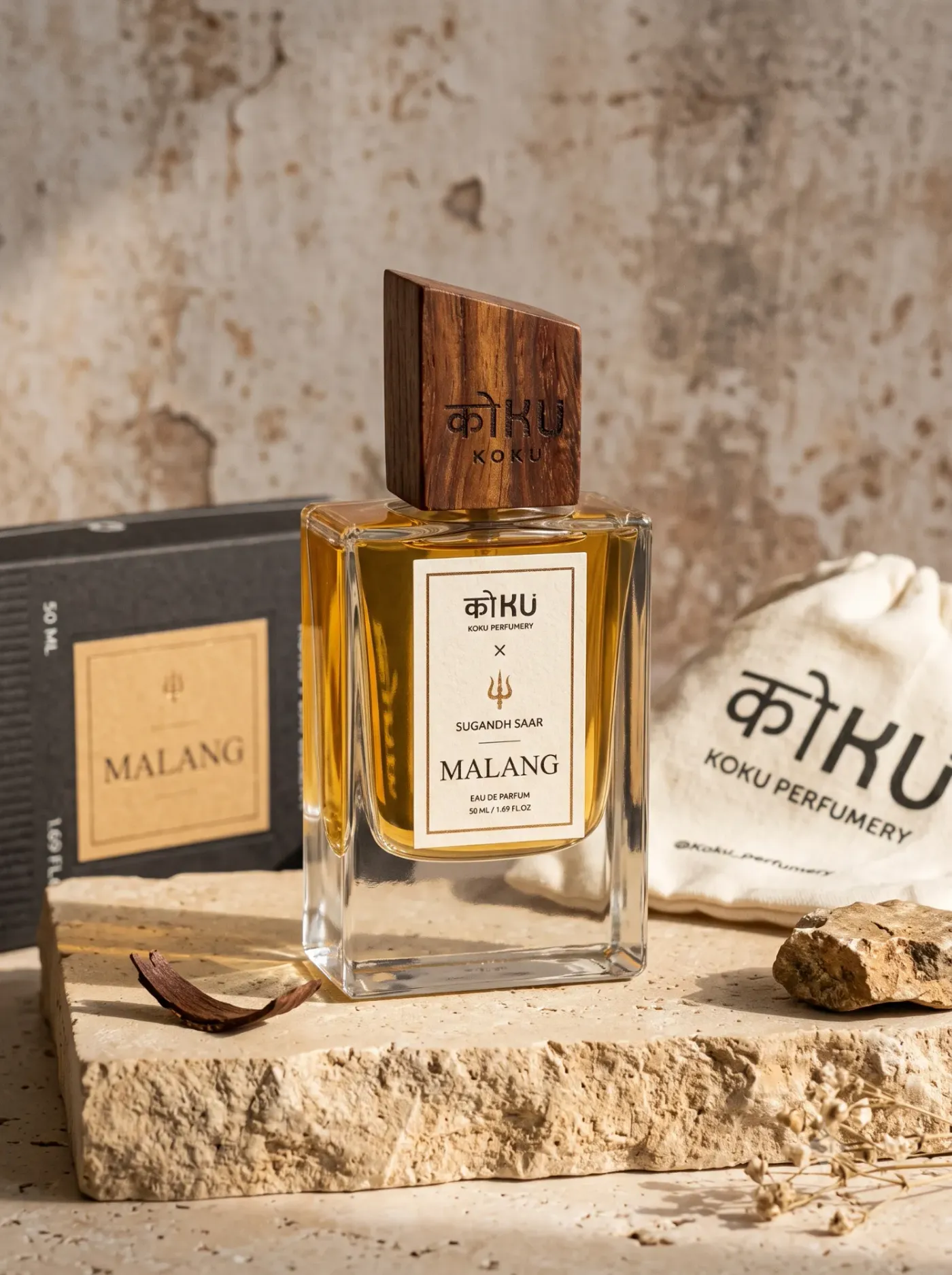 A bottle of Malang with its box and pouch on a stone slab